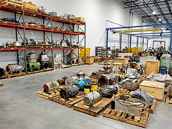 Interior of CPR warehouse with assorted centrifuge parts in foreground